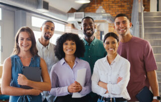 Smiling office team of six men and women.