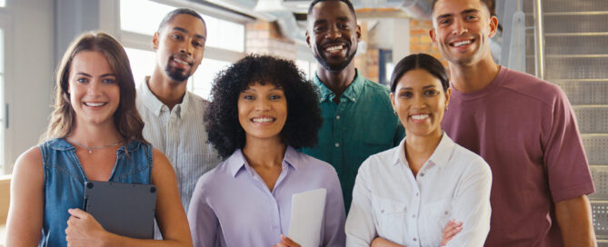 Smiling office team of six men and women.