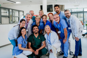 Large group of Nurses and Doctors standing together and smiling in a hospital