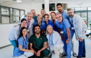 Large group of Nurses and Doctors standing together and smiling in a hospital