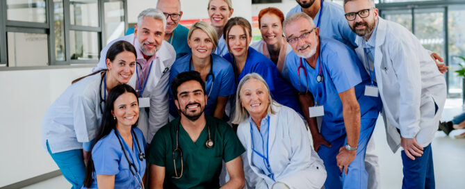 Large group of Nurses and Doctors standing together and smiling in a hospital